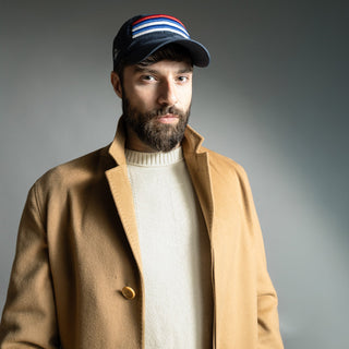 Dark Yarn Nautilus Reserve Dockside Cap, a stylish navy blue headwear with adjustable strap and nautical-inspired design.
