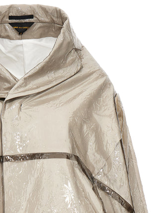 Gray polyethylene coat by Comme Des Garçons, featuring a sleek design with a hood and long sleeves, suitable for casual wear.