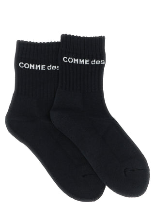 Bicolor cotton socks from Comme Des Garçons featuring black and white color blocks, soft cotton material, and a comfortable fit.