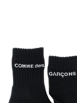 Bicolor cotton socks by Comme Des Garçons featuring contrasting colors and a comfortable knit design.