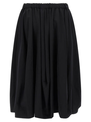 Black wool mini skirt by Comme Des Garçons, showcasing a fitted silhouette and minimalist design.