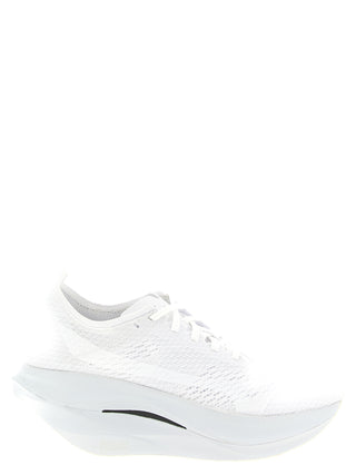 White synthetic athletic sneakers by Comme Des Garçons with sleek design, laces, and sporty sole for active wear.