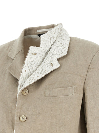 Beige linen blazer by Comme Des Garçons, tailored fit with classic lapels and button closure, displayed on a hanger.