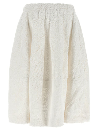 White cotton midi skirt by Comme Des Garçons, shown with a flowing, knee-length design and minimalist style.