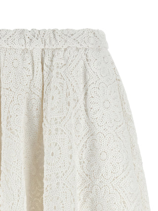 White cotton midi skirt by Comme Des Garçons, featuring a sleek, flowing design and midi length, ideal for casual or dressy outfits.