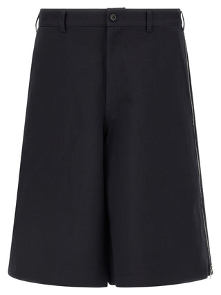 Blue polyester Bermuda shorts by Comme Des Garçons, showcasing a relaxed fit and casual style with a smooth fabric finish.