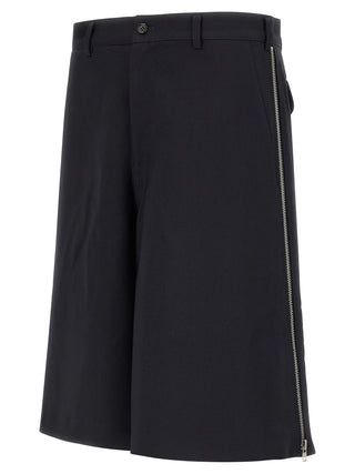 Blue polyester Bermuda shorts by Comme Des Garçons, featuring a relaxed fit and casual style, shown on a plain background.