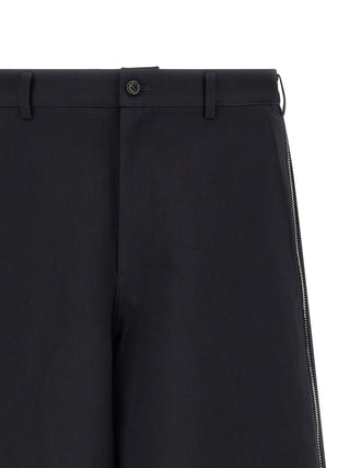 Blue polyester Bermuda shorts by Comme Des Garçons, featuring a relaxed fit and casual style, shown on a model.
