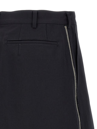 Blue polyester Bermuda shorts by Comme Des Garçons, featuring a relaxed fit and casual style, shown on a white background.