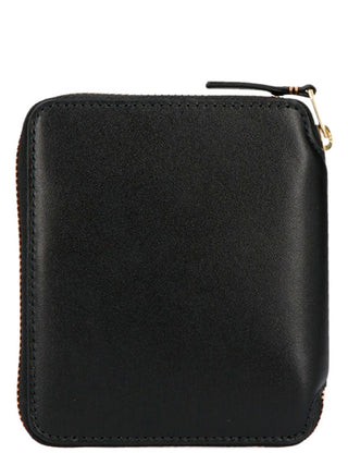 Black calfskin wallet by Comme Des Garçons featuring a sleek, minimalist design and compact size.