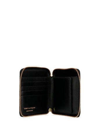 Black calfskin wallet by Comme Des Garçons showing sleek leather design with multiple card slots and minimalist style.