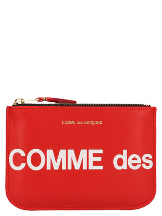 Red calfskin cardholder by Comme Des Garçons featuring multiple card slots and sleek, minimalist design.