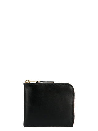 Black calfskin wallet by Comme Des Garçons with multiple card slots and sleek minimalist design.