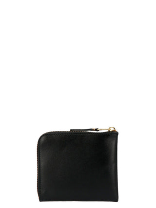 Black calfskin wallet by Comme Des Garçons featuring a sleek, minimalist design with multiple card slots and a secure bill compartment.