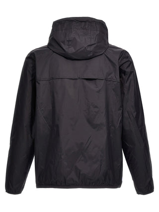 Blue nylon shell jacket by Comme Des Garçons Play, lightweight outerwear with a smooth fabric and minimalist design.