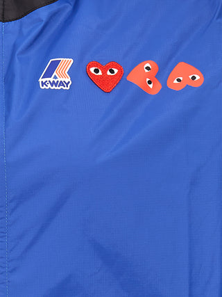 Blue nylon shell jacket by Comme Des Garçons Play, lightweight outerwear with a smooth finish and minimalist design.