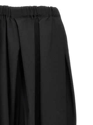 Black wool midi skirt by Comme Des Garçons, featuring a sleek, tailored design with a high waist and midi length.