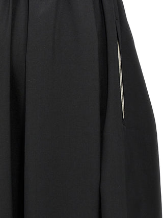 Black wool midi skirt by Comme Des Garçons, featuring a sleek, mid-length design with a smooth fabric texture.