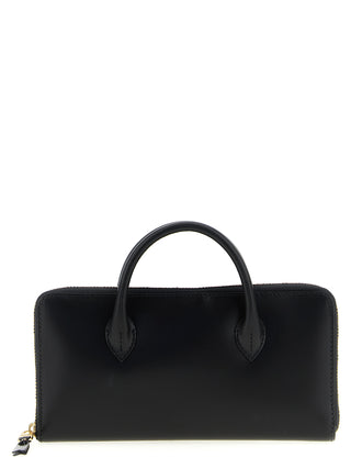 Black cowhide cardholder by Comme Des Garçons with multiple card slots and sleek minimalist design.