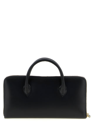 Black cowhide cardholder by Comme Des Garçons with multiple card slots and minimalist design.