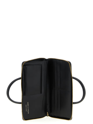 Black cowhide cardholder by Comme Des Garçons featuring multiple card slots and sleek minimalist design.