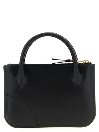 Black cowhide cardholder by Comme Des Garçons with multiple card slots and sleek minimalist design.