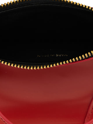 Red cowhide cardholder from Comme Des Garçons with multiple card slots and a sleek, minimalist design.