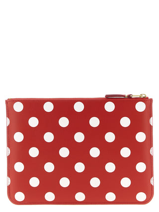 Red calfskin wallet by Comme Des Garçons with a sleek, minimalist design and compact size.