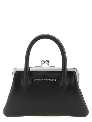 Black cowhide cardholder by Comme Des Garçons with multiple card slots and sleek minimalist design.