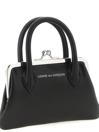 Black cowhide cardholder by Comme Des Garçons with multiple card slots and sleek minimalist design.