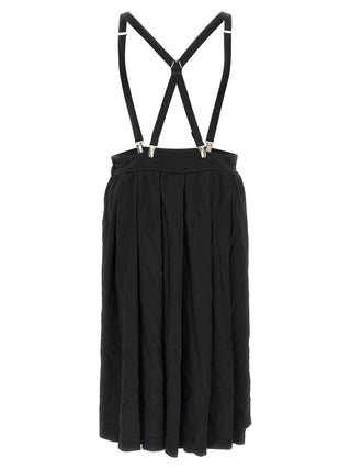 Black polyester midi skirt by Comme Des Garçons, shown with a flowing, high-waisted design and sleek fabric texture.