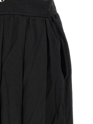 Black polyester midi skirt by Comme Des Garçons, showcasing a sleek, modern design with a smooth fabric finish and midi length cut.
