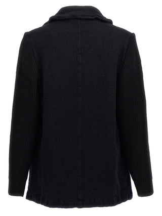 Blue wool coat by Comme Des Garçons, featuring a classic tailored design and button details, displayed on a hanger.