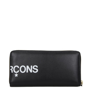 Black leather wallet by Comme Des Garçons with multiple card slots and sleek design, shown open with interior compartments visible.