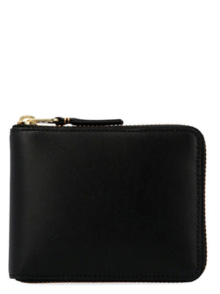Black calfskin cardholder by Comme Des Garçons showing multiple card slots and sleek, minimalist design.