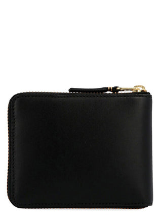 Black calfskin cardholder by Comme Des Garçons showing multiple card slots and sleek minimalist design.