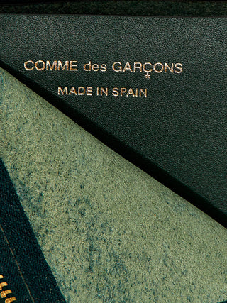 Bicolor calfskin cardholder by Comme Des Garçons with sleek design and multiple card slots.