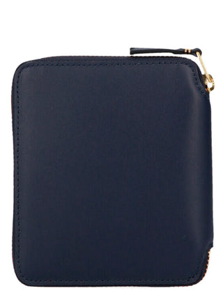 Blue calfskin wallet by Comme Des Garçons with multiple card slots and sleek design on a plain background.