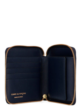 Blue calfskin wallet by Comme Des Garçons with sleek design and compact size, featuring multiple card slots and a minimalist style.