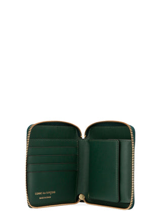 Bicolor calfskin wallet by Comme Des Garçons with sleek design and multiple card slots, featuring contrasting colors.