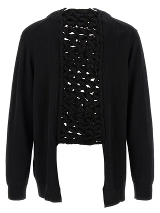Black wool cardigan by Comme Des Garçons, featuring a cozy knit texture and classic design, displayed on a neutral background.