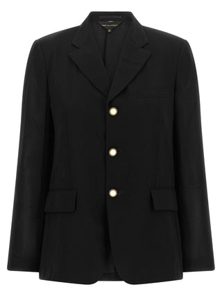 Black polyester blazer by Comme Des Garçons, tailored fit with lapel collar, displayed on a hanger against a neutral background.
