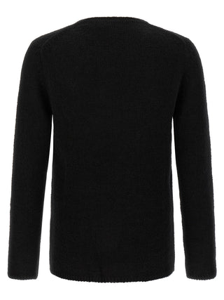 Black polyester cardigan by Comme Des Garçons, featuring a classic knit design and button closure.