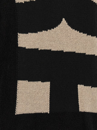 Black polyester cardigan by Comme Des Garçons, featuring a lightweight, relaxed fit with button closure and ribbed cuffs.