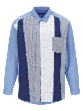 Blue cotton blouse by Comme Des Garçons, featuring a relaxed fit and modern design, displayed on a hanger.