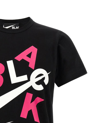 Black cotton T-shirt by Comme Des Garçons, featuring a simple crew neck design and soft fabric, displayed on a plain background.