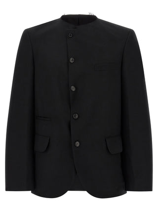 Black wool blazer by Comme Des Garçons, tailored fit with structured shoulders and classic lapel, displayed on a neutral background.