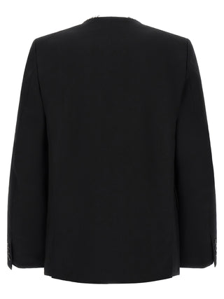 Black wool blazer by Comme Des Garçons, tailored fit with classic lapels, displayed on a hanger.