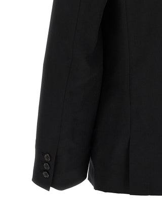 Black wool blazer by Comme Des Garçons, tailored fit with notched lapels and structured design, displayed on a hanger.