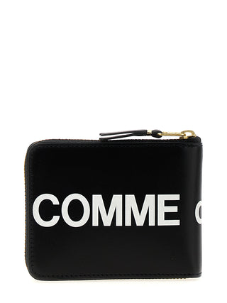 Bicolor calfskin cardholder by Comme Des Garçons with sleek design and multiple card slots on a neutral background.
